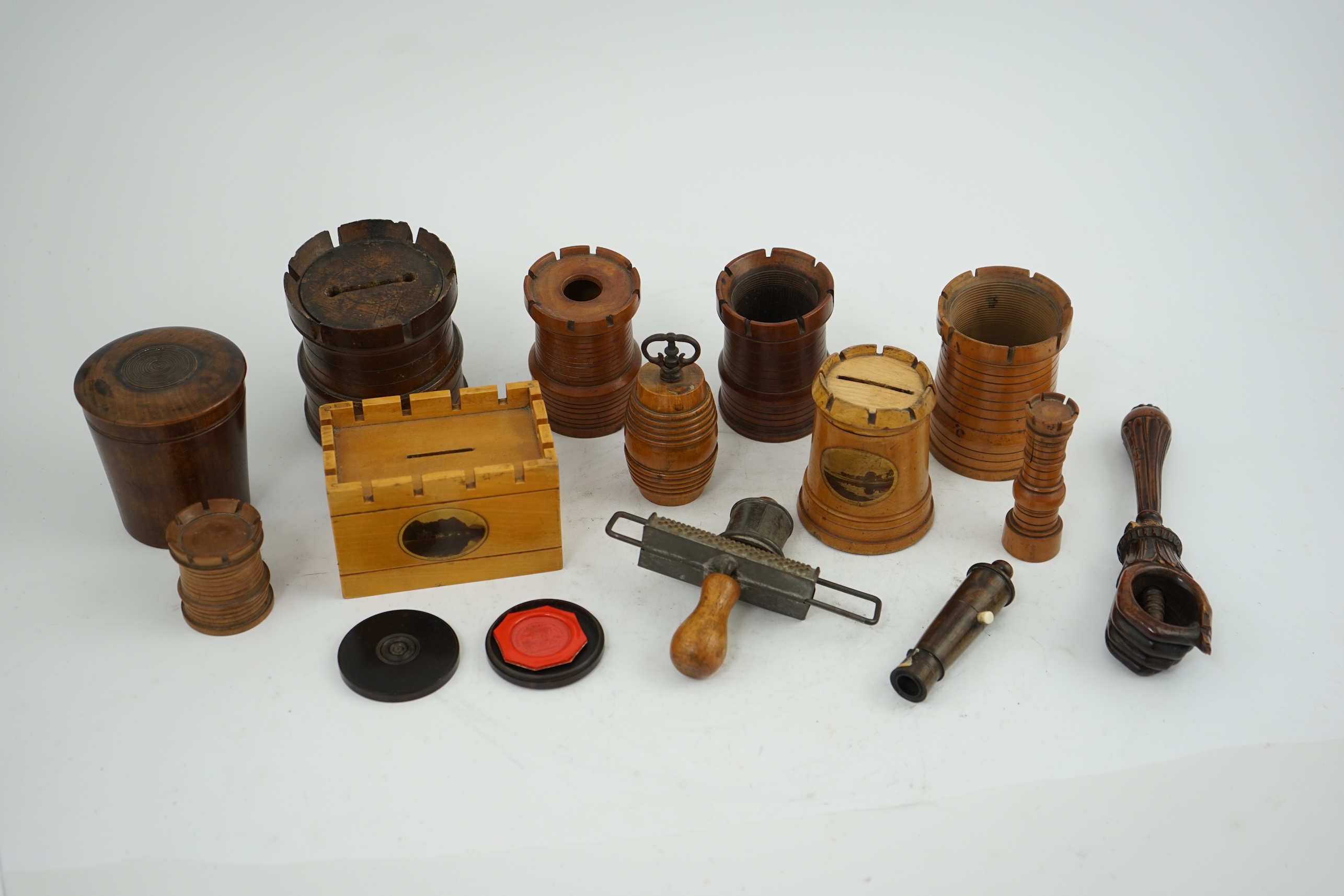 A collection of Victorian and Edwardian treen comprising castellated boxes, nutcrackers, kitchenalia and a glass holder. Condition - fair to good
